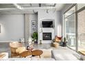 Cozy living area with fireplace, modern furniture, and industrial-style ceiling at 2899 N Speer Blvd # 203, Denver, CO 80211