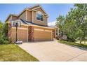 Charming two-story home with a three-car garage and inviting curb appeal at 10089 Wynwood Way, Highlands Ranch, CO 80126