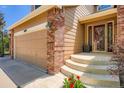 Inviting front porch with elegant brick accents and a well-maintained walkway at 10089 Wynwood Way, Highlands Ranch, CO 80126