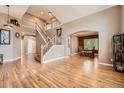 Spacious living room with gleaming hardwood floors and a grand staircase at 10089 Wynwood Way, Highlands Ranch, CO 80126