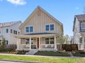 Charming two-story home featuring a cozy front porch and professionally landscaped yard at 5511 Wabash St, Denver, CO 80238