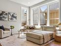 Bright living area with large windows, a comfortable sectional, and elegant decor at 5511 Wabash St, Denver, CO 80238