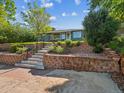 View of front yard, featuring a charming home and steps with a retaining wall at 4112 S Galapago St, Englewood, CO 80110