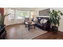 Cozy living room with hardwood floors, large windows, and comfortable leather seating at 4112 S Galapago St, Englewood, CO 80110