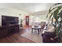 Bright living room featuring hardwood floors, a comfortable sofa, and ample natural light at 4112 S Galapago St, Englewood, CO 80110