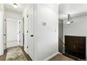 Bright hallway featuring wood floors, white trim, and stairway to the upper level at 4604 Routt St, Wheat Ridge, CO 80033