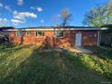 View of the backyard of a brick home with windows and a door at 106 Emerald St, Broomfield, CO 80020