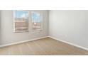 Neutral bedroom with carpet, light walls, and a double window at 2985 Oxley St, Strasburg, CO 80136