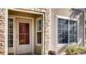 Charming entryway with stone detailing, a storm door, and a bright window with privacy blinds at 10165 E Carolina Pl # 102, Aurora, CO 80247