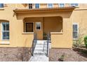 Charming covered front porch with wrought iron railing, providing curb appeal to this home at 7777 E 23Rd Ave # 201, Denver, CO 80238