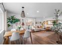 Open-concept living and dining area with hardwood floors and bright natural light at 290 Pierce St, Lakewood, CO 80226