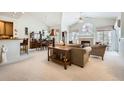 Bright living room with high ceilings, fireplace, and plush seating offers a cozy and inviting atmosphere for relaxation at 4143 Da Vinci Dr, Longmont, CO 80503
