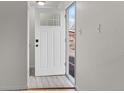 Bright entryway with new white door and tiled flooring at 12516 E Alaska Ave, Aurora, CO 80012