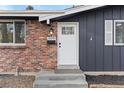 Renovated front entrance with new door, steps, and landscaping at 12516 E Alaska Ave, Aurora, CO 80012