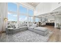 Open-concept living area with a large sectional sofa, a fireplace, and backyard views at 423 N Snowmass Cir, Superior, CO 80027