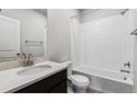 Modern bathroom features a shower-tub combo and a granite countertop vanity at 14441 Clover Dr, Mead, CO 80504