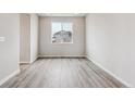 Clean bedroom featuring sleek flooring and a bright window with neighborhood views at 14441 Clover Dr, Mead, CO 80504