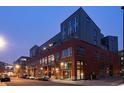 Brick apartment building with large windows and modern design at dusk at 2955 Inca St # 2F, Denver, CO 80202