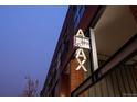 An illuminated sign for the building, reading 'AJAX Lofts' in a stylized font at 2955 Inca St # 2F, Denver, CO 80202