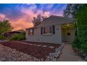 Charming home with well-maintained front yard and unique landscaping under a beautiful sky at 1645 Wabash St, Denver, CO 80220