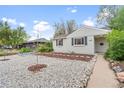 Charming home with a well-kept front yard featuring attractive and sustainable rock ground cover at 1645 Wabash St, Denver, CO 80220