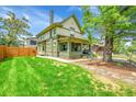 Beautiful two-story home with a well-manicured lawn and mature trees at 2143 S Acoma St, Denver, CO 80223
