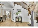 Welcoming foyer with hardwood floors, a staircase, and stylish decor at 2143 S Acoma St, Denver, CO 80223