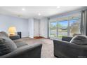 Cozy living room with natural light, plush seating, and a view of the front yard at 2698 Fern Dr, Westminster, CO 80030