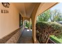 Arched front porch showcasing brick accents and providing a welcoming entrance to the home at 8228 Marshall Ct, Arvada, CO 80003