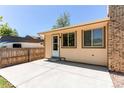 Back patio, complete with neutral-colored siding, access door, and plenty of space for outdoor living at 8228 Marshall Ct, Arvada, CO 80003