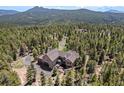 Stunning aerial view of a home nestled among lush trees, showcasing the vast and serene surrounding landscape at 11421 Belle Meade Dr, Conifer, CO 80433