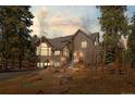 Inviting home exterior features a stone facade and steps leading to the entrance at 11421 Belle Meade Dr, Conifer, CO 80433