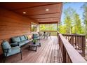Relaxing outdoor deck with comfortable seating, perfect for enjoying nature and entertaining guests at 11457 Nancys Dr, Conifer, CO 80433
