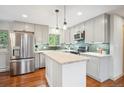 Modern kitchen with stainless steel appliances, gray cabinets, and a wood countertop island at 11457 Nancys Dr, Conifer, CO 80433