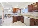 Charming kitchen with stainless steel appliances and a view of the dining area at 12097 E Mexico Ave, Aurora, CO 80012