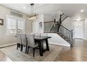 Formal dining room featuring a modern chandelier, staircase and natural light at 7301 S Shady Grove Way, Aurora, CO 80016