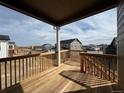 Wooden deck with railing and views of neighborhood at 6966 E 126Th Pl, Thornton, CO 80602