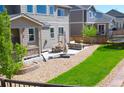 Expansive backyard with a stone patio, lush green lawn, and ample space for outdoor entertaining at 7258 Oasis Dr, Castle Rock, CO 80108