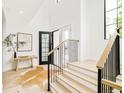 Bright foyer boasts hardwood floors, modern railing, and an open entryway with lots of natural light at 2773 S Garfield St, Denver, CO 80210