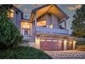 Charming two-story home featuring a two-car garage, balcony, and mature trees at 386 Monte Vista Rd, Golden, CO 80401