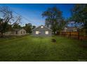 Spacious backyard with lush green grass and a fire pit at 6104 Hudson St, Commerce City, CO 80022