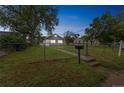 The lovely home is surrounded by mature trees and a lush front yard at 6104 Hudson St, Commerce City, CO 80022