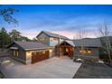 Charming home with a three-car garage, inviting front entrance, and a well-maintained concrete driveway at 1055 Divide View Dr, Golden, CO 80403