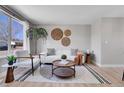 Bright living room with a large window, stylish furniture, and contemporary decor at 7054 Welch Ct, Arvada, CO 80004