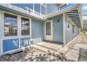 Inviting front entrance with blue siding and concrete steps, leading to unit 264 at 264 S Newark Cir, Aurora, CO 80012