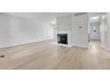 Bright living room with a fireplace and light wood floors at 264 S Newark Cir, Aurora, CO 80012