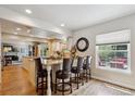 Open kitchen features a granite island with seating, modern lighting, and ample counter space at 5225 S Everett Ct, Littleton, CO 80123