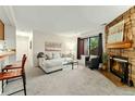 Cozy living room with a fireplace and large windows, providing ample natural light at 6388 Oak Ct # 104, Arvada, CO 80004