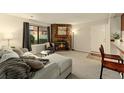 Comfortable living room with carpet, natural light and a stone fireplace at 6388 Oak Ct # 104, Arvada, CO 80004