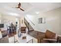 Open-concept living room with hardwood floors, staircase, and a ceiling fan offering both style and functionality at 3932 Tejon St, Denver, CO 80211